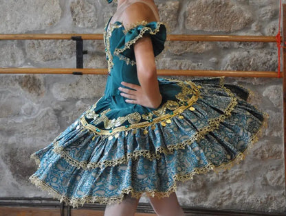 girl wearing emerald and gold tutu