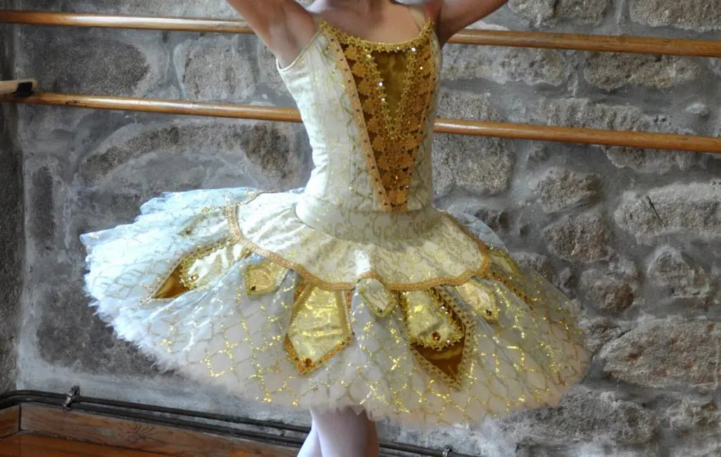 girl dancing with golden tutu