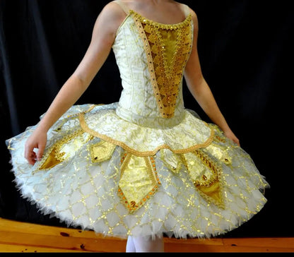 girl posing with golden tutu