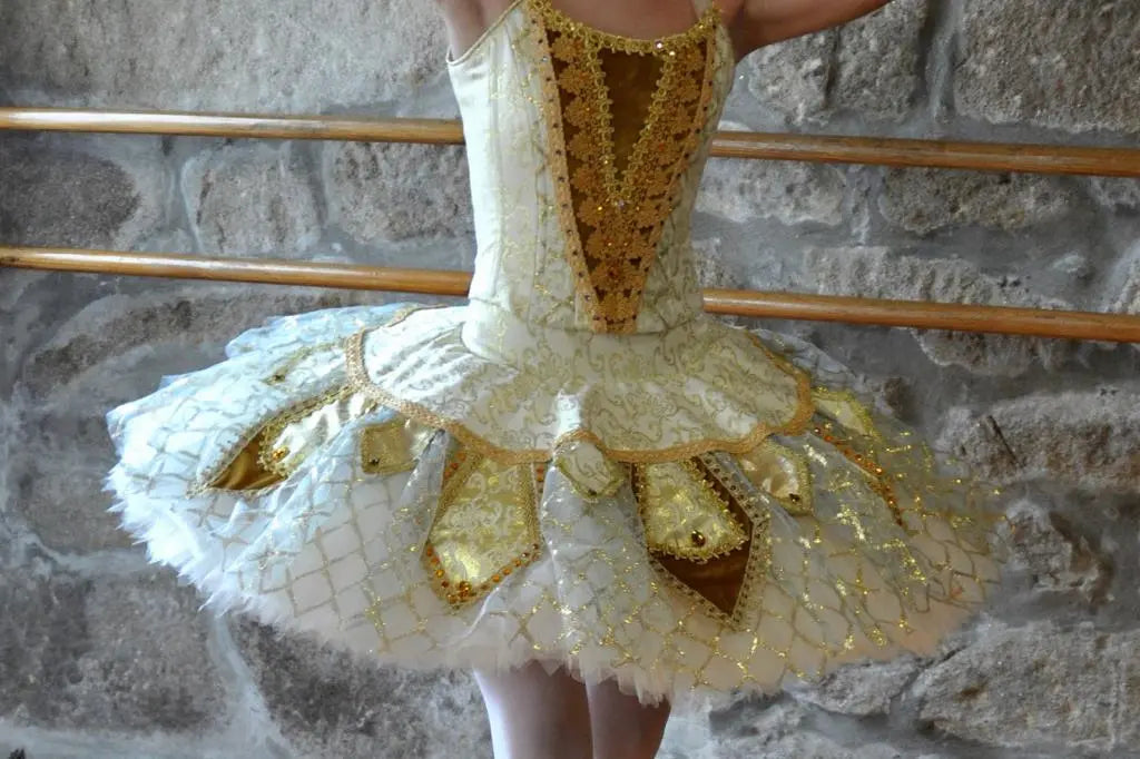 girl wearing golden tutu